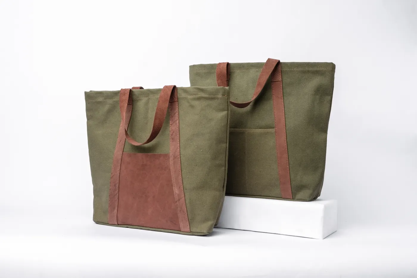 Two Felek green canvas conference bags with leather trims