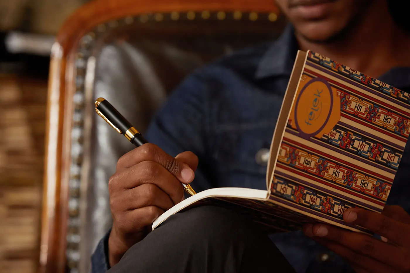 Writing in a Felek journal with an Ethiopian woven cover